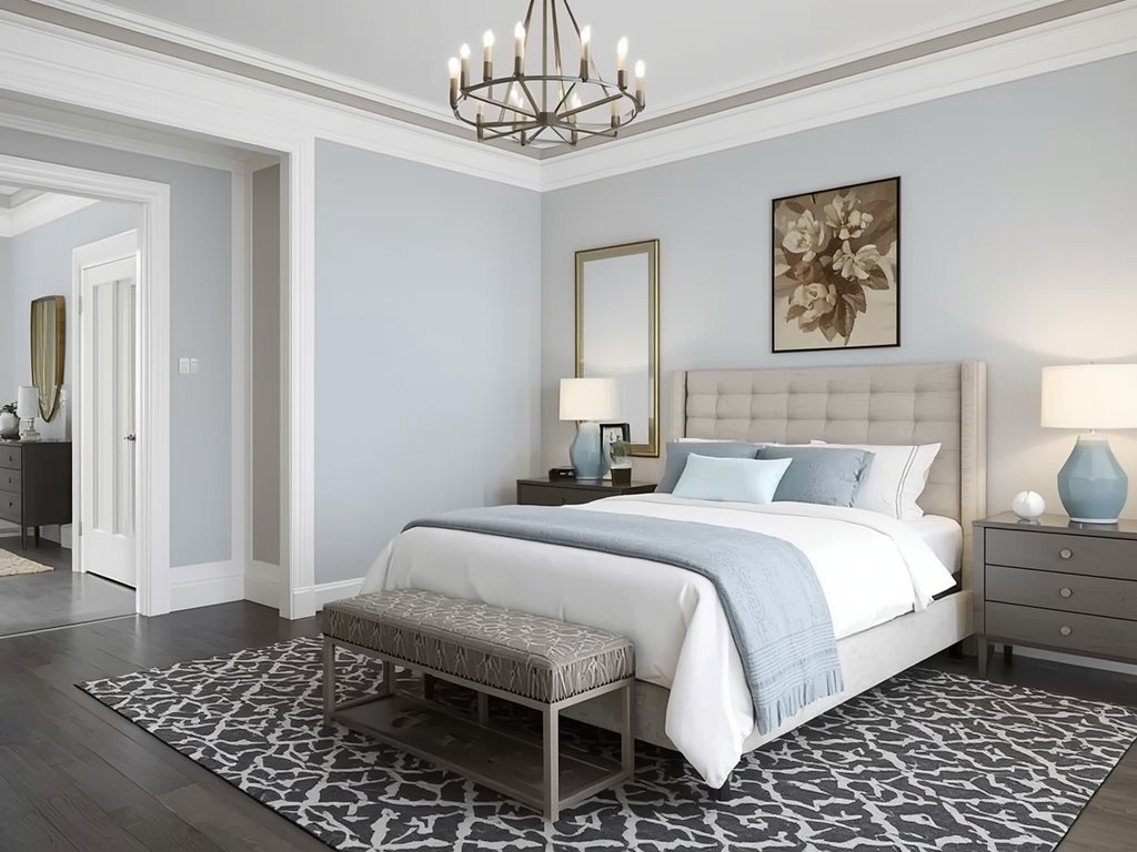 A bedroom with a geometric patterned rug in